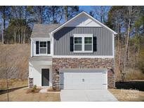 Two-story house with gray siding, stone accents, and a two-car garage at 34 Porter Nw St # Sw34, Concord, NC 28027