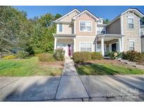 Inviting two-story townhouse featuring a well-manicured lawn and a charming, covered entryway at 1111 Constitution Park Blvd, Rock Hill, SC 29732