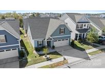 Two-story house with a gray roof, two-car garage, and landscaped yard at 50143 Robins Nest Ln, Lancaster, SC 29720