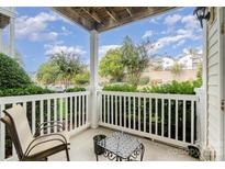 Inviting porch with white railings, outdoor seating, and a view of landscaped surroundings at 11264 Hyde Pointe Ct, Charlotte, NC 28262