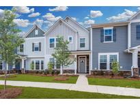 Charming townhomes featuring various blue and gray color schemes, stone accents, and professionally landscaped yards at 10105 Mamillion Dr, Huntersville, NC 28078