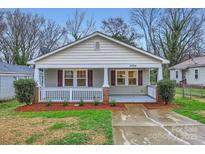 Charming single-story home featuring a cozy front porch with brick accents and a well-maintained lawn at 3004 Ridge Ave, Charlotte, NC 28208