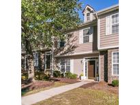 Charming townhome with neutral siding, stone accents, well-maintained landscaping, and inviting walkway at 563 Goldstaff Ln, Charlotte, NC 28273