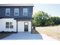 Charming two-story home with black and white exterior, covered entry and concrete driveway at 818 Fairview St # A, Kannapolis, NC 28083