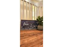 Wooden table with framed art and plant at 10105 Reindeer Way Ln, Charlotte, NC 28216
