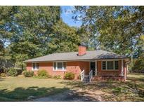 Charming brick ranch-style home with well-maintained landscaping and a classic architectural design at 220 Hazel St, China Grove, NC 28023