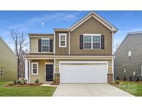 Charming two-story home featuring a two-car garage, black shutters, and manicured lawn at 110 Dorian Pl, Troutman, NC 28166