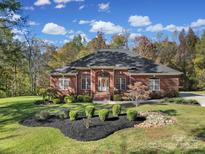 Beautiful brick home featuring manicured lawn and a charming front entryway with mature trees at 1567 Fayrene Rd, Rock Hill, SC 29732