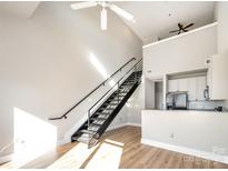 Open living area with loft, modern staircase, and hardwood floors at 115 E Park Ave # 419, Charlotte, NC 28203