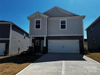 Charming two-story home featuring stone accents, a two-car garage, and a well-maintained front yard at 1276 31St Ne St, Conover, NC 28613