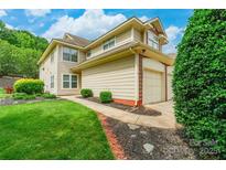 Charming two-story home with attached garage, landscaped yard, and inviting curb appeal at 5832 Amity Springs Dr, Charlotte, NC 28212