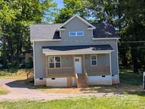 Charming home featuring a covered porch and a classic gray color scheme at 1506 7Th St, Statesville, NC 28677