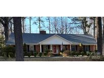 Charming brick home with a well-manicured lawn and mature trees offering great curb appeal at 5444 Marengo Cir, Charlotte, NC 28216
