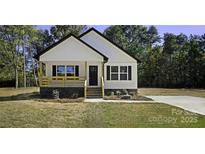 Charming craftsman-style home with white siding, black trim, and a cozy front porch at 615 Charles St, Rockwell, NC 28138
