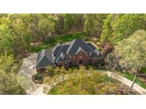 Sprawling estate aerial showcasing circular driveway, mature trees, and manicured lawn at 9723 Sedgefield Dr, Waxhaw, NC 28173