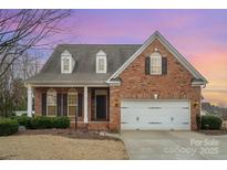 Charming brick home featuring a two-car garage and well-manicured landscaping at 1001 Hatton Ter, Fort Mill, SC 29707