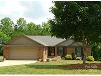Charming single-story brick home with a two-car garage and beautifully landscaped front yard at 2015 Pine Needle Ct, Gastonia, NC 28056