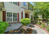 Charming home with well-maintained landscaping and inviting front porch exudes curb appeal at 3007 Gambrill Falls Dr, Indian Trail, NC 28079