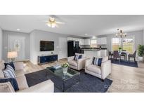 Open living room, kitchen, and dining area with light flooring and neutral colors at 301 Walkers Ridge Dr, Shelby, NC 28152