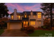 Charming two-story home with a well-manicured lawn, attached garage, and inviting entrance at 501 River Oaks Ln, Charlotte, NC 28226