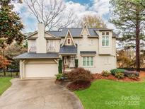 Charming two-story home with a well-manicured lawn, mature trees, and a two-car garage at 501 River Oaks Ln, Charlotte, NC 28226