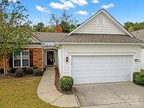 Charming home featuring a two-car garage and a mix of brick and siding on the exterior at 20195 Dovekie Ln, Fort Mill, SC 29707