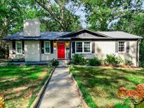 Charming ranch home featuring a bright red front door and a classic brick facade at 508 Deese St, Monroe, NC 28112
