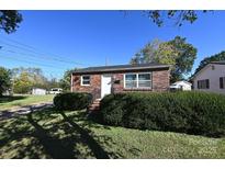 Charming brick home with well-maintained landscaping and a welcoming front entrance at 125 S Ervin Ave, Newton, NC 28658