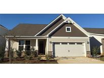 Inviting home with a two-car garage, stone accents, neutral siding, and a well-manicured front yard at 1032 Bull Dog Ln, Wingate, NC 28174