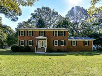 Brick ranch home with a large yard and mature trees at 316 Carter Rd, Monroe, NC 28110