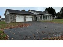 Stone house with a two-car garage and large yard at 2022 Friendship Church Rd, Taylorsville, NC 28681