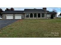 Stone house with a two-car garage and large yard at 2022 Friendship Church Rd, Taylorsville, NC 28681