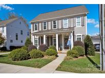 Two-story house with gray siding, shutters, and a front porch at 376 Delburg St, Davidson, NC 28036