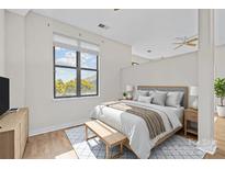 Bright bedroom featuring hardwood floors, neutral walls, and a picturesque window view at 708 N Davidson St, Charlotte, NC 28202