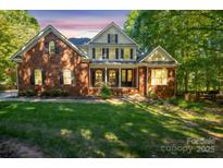 Brick house with a large front yard and mature trees at 128 Archbell Point Ln, Mooresville, NC 28117