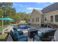 Relaxing backyard oasis featuring a sparkling in-ground pool with deck and seating at 357 China Grove Rd, Kannapolis, NC 28083