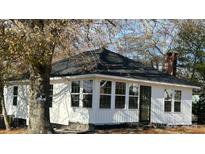 Charming white home with a new roof and windows, located on a partially wooded lot at 7608 Kershaw Camden Hwy, Kershaw, SC 29067