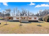 Ranch style home with a covered porch and large yard at 119 Loray Ln, Statesville, NC 28625