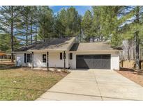 Charming single-story home with a two-car garage and inviting front porch nestled among mature trees at 1969 Beth Haven Church Rd, Denver, NC 28037