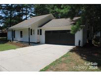 Charming one-story home with a black garage door and landscaped yard at 1969 Beth Haven Church Rd, Denver, NC 28037