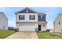 Charming two-story home featuring blue and white accents, a two-car garage, and a well-manicured front lawn at 117 Dorian Pl, Troutman, NC 28166