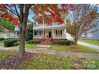 Two-story home with double porches, a brick foundation, and beautifully landscaped front yard in a mature neighborhood at 1360 Barnett Woods, Fort Mill, SC 29708