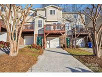 Tan 3-story townhome with multiple balconies and attached garage at 127 High Ridge Rd, Mooresville, NC 28117