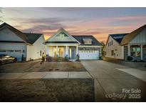 Stunning curb appeal with stone accents and a welcoming front porch at 216 Portrait Way, Indian Trail, NC 28079