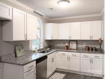 Modern kitchen with white cabinets, granite countertops, and stainless steel appliances at 5105 Chelsey Ln, Monroe, NC 28110