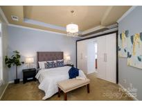 Spacious bedroom with plush bed, ample closet space, and calming decor at 8428 Loxton Cir, Charlotte, NC 28214