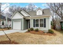 Charming craftsman style home with gray siding, white trim, and a two-car garage at 112 Bickett Ave, Gastonia, NC 28052