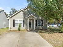 Charming single-story home with gray siding, black shutters, and a concrete driveway at 1623 Forest Stream Ct, Charlotte, NC 28213