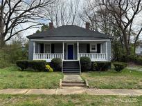 Charming home featuring a welcoming front porch and a well-maintained front yard at 322 S Liberty St, Gastonia, NC 28052