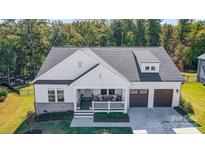Stunning craftsman-style home with a welcoming front porch and manicured landscaping in a serene neighborhood at 4116 Spring Cove Way, Belmont, NC 28012